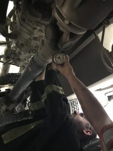 Worker performing hydraulic system repair