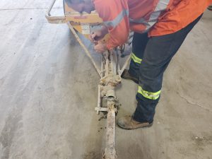 Worker Performing Pump Repair