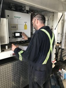 Technician working on a machine panel